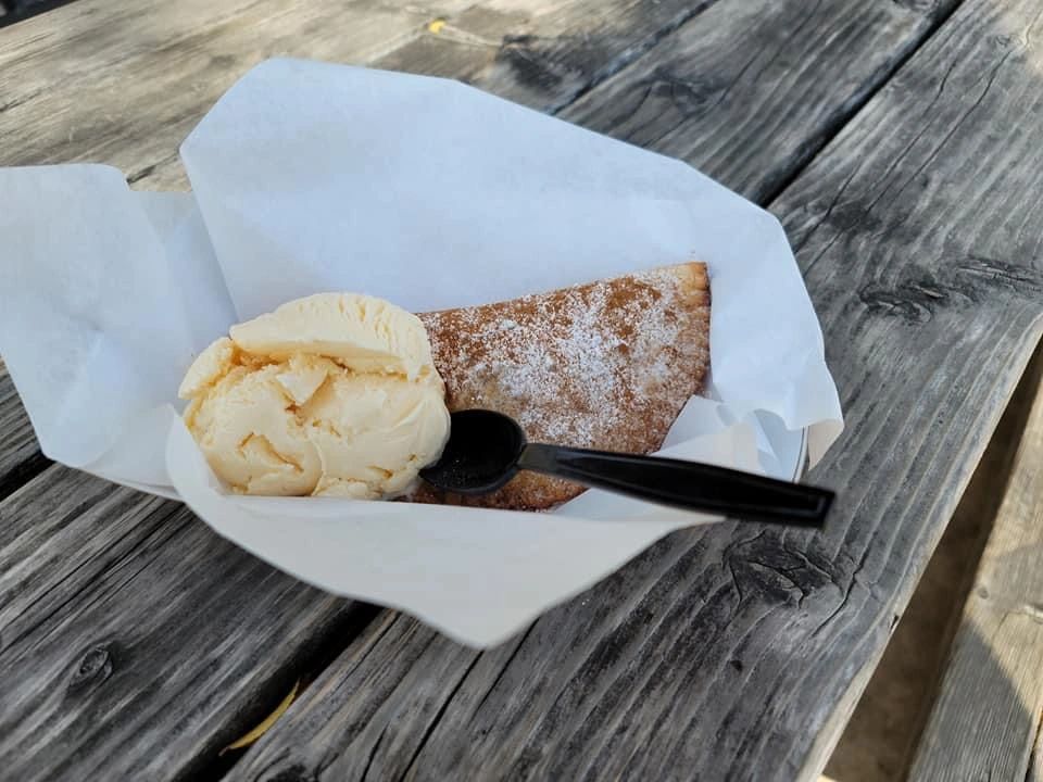 Fried pie and ice cream dessert served in a paper boat